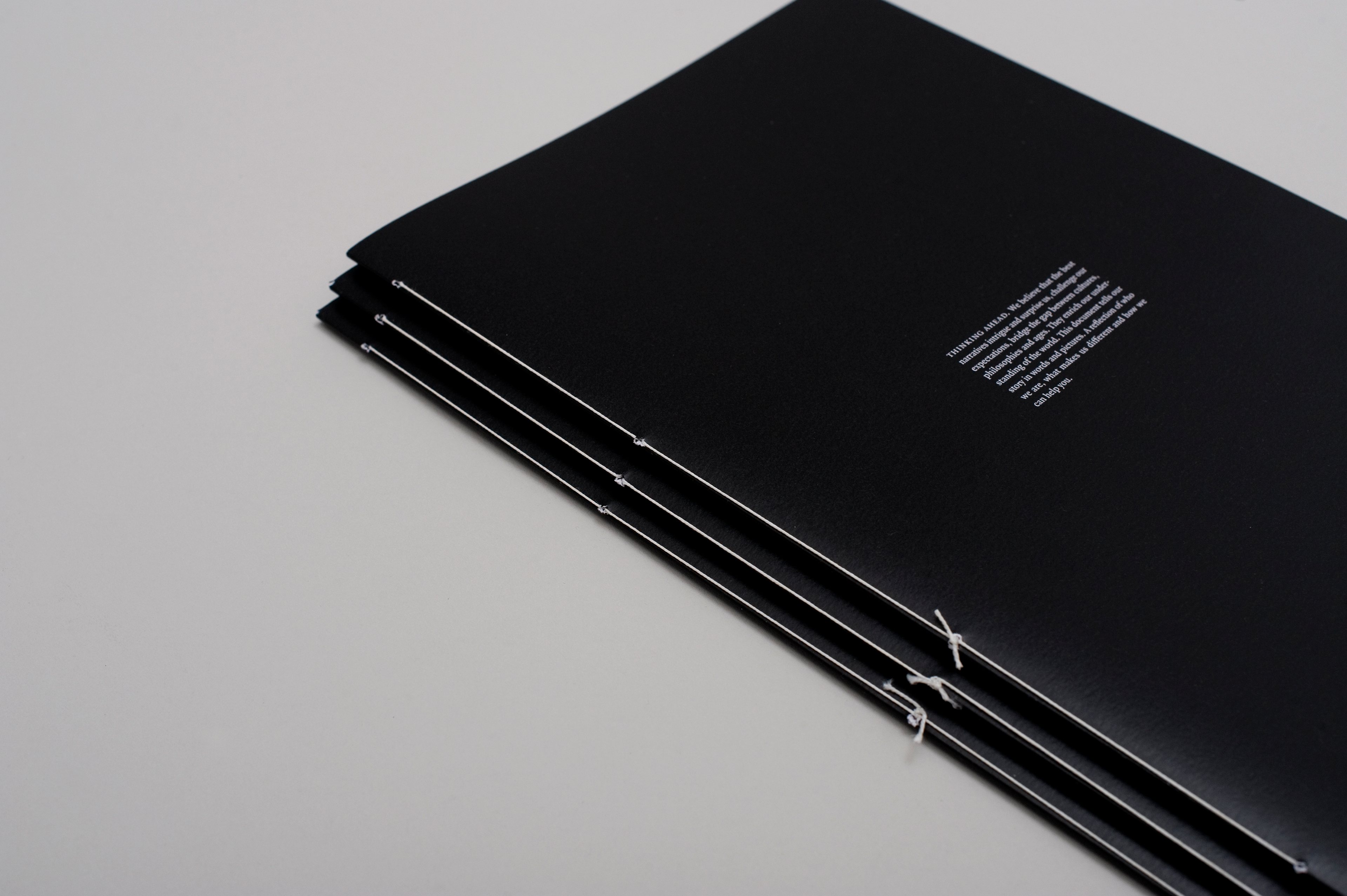 Thread bound cover design for a legal firm brochure.